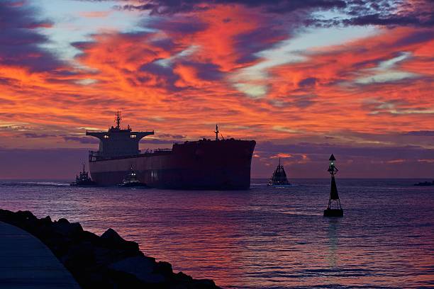 Bulk Carrier Entering Harbour at Sunrise stock photo