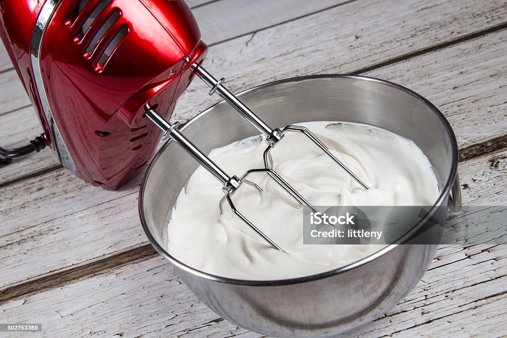 Whipped Cream Electric hand mixer with whipped cream Electric Mixer Stock Photo