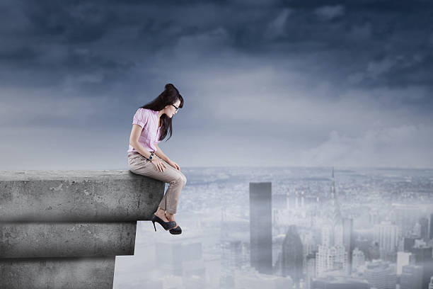 istock Woman looking down from the rooftop 502753755