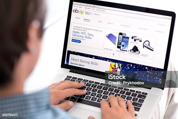 Man Sitting The Macbook Retina With Site Paypal On Screen Stock Photo - Download Image Now