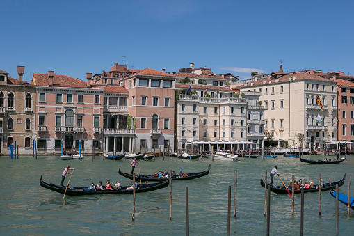 venice, italy - May 17, 2014: People are riding traditional gondolas at grand channel of venice italy