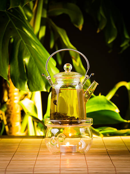 istock Chinese teapot with tea, on a burning support from glass 502754944