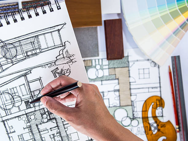 istock Architect's hands drawing home illustration with material sample, renovation  concept 502755199
