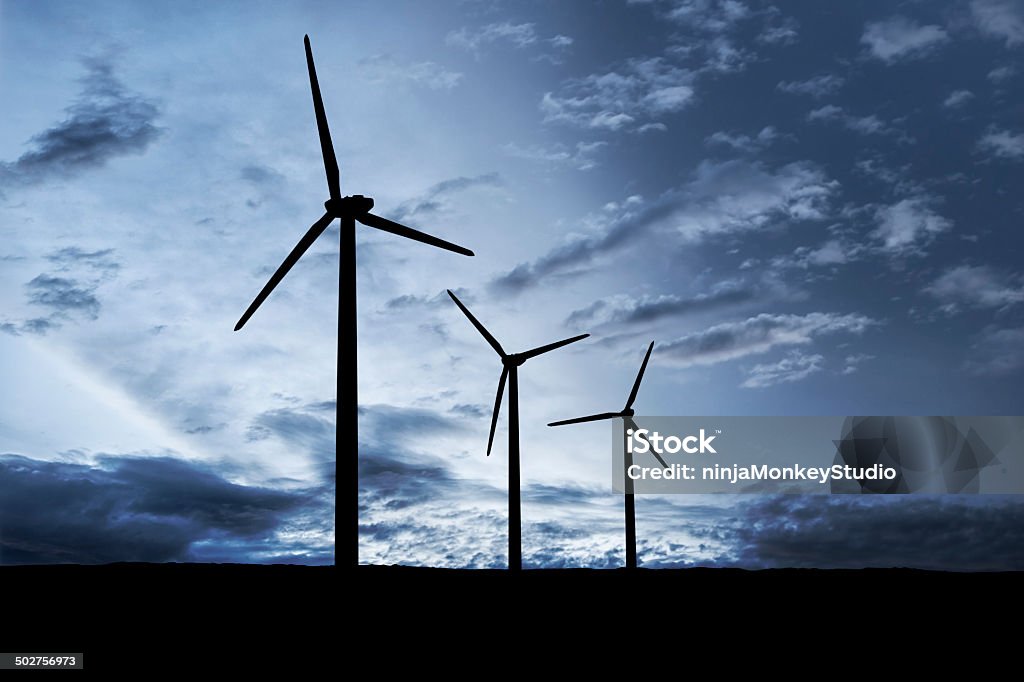 Wind Mill Turbine Silhouette at Dusk Windmill generate clean energy at dusk. Night Stock Photo