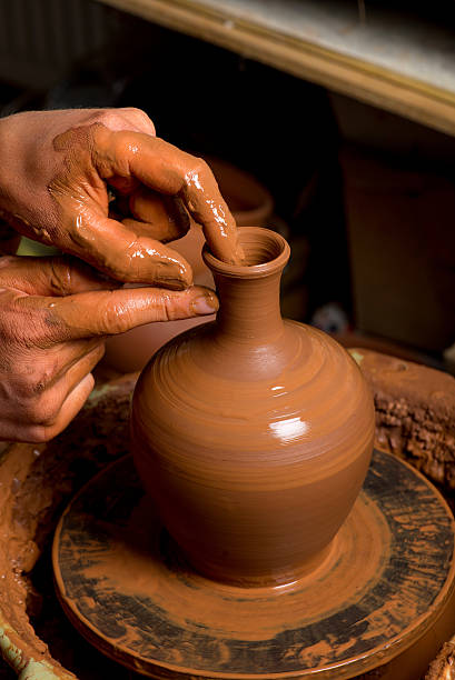 istock hands of a potter, creating an earthen jar 502757871