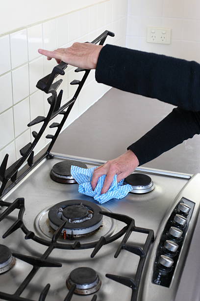 Cleaning the Stove Part of my cleaning series cleaning stove domestic kitchen human hand stock pictures, royalty-free photos & images