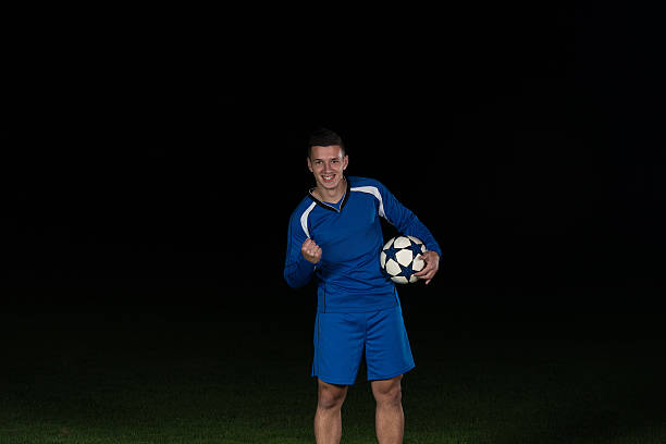 istock Soccer Player Celebrating The Victory On Black Background 502760660