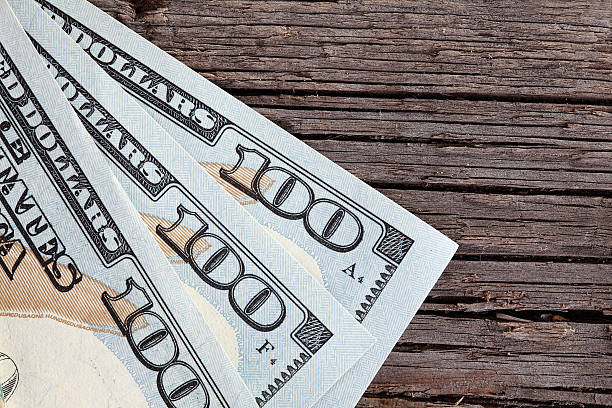 istock Dollars on wooden background for your use 502763888