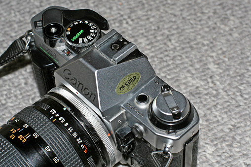 Victoria, Canada - May 18, 2010: Silver Canon AE-1 Program film camera with Tamron zoom lens.