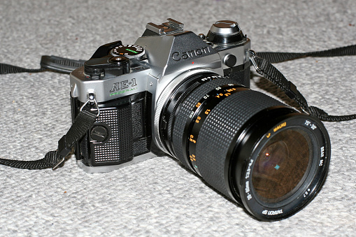 Victoria, Canada - May 18, 2010: Silver Canon AE-1 Program film camera with Tamron zoom lens.