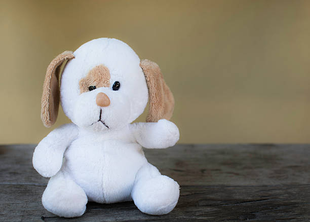 istock White dog doll/toy sitting 502775742