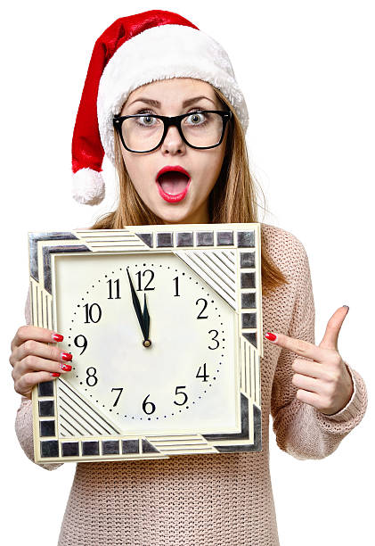istock Girl in Christmas hat with clock. 502782398
