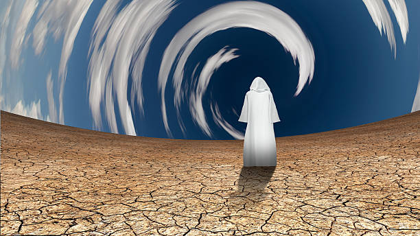 istock Desert and circular sky with wandering cloaked figure 502784064