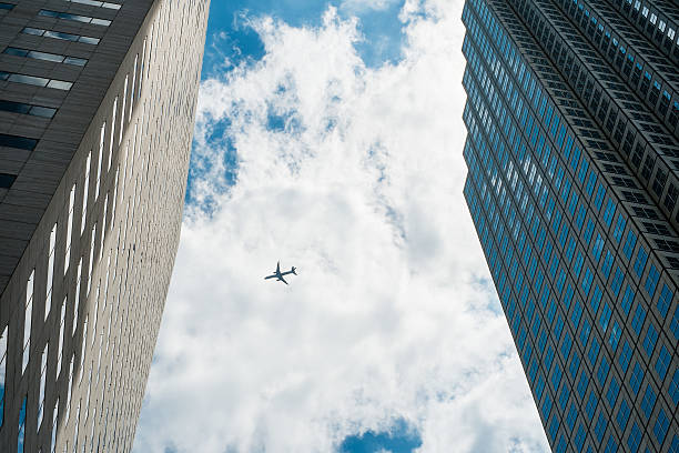istock Airplane in the sky against skyskrapers 502786199