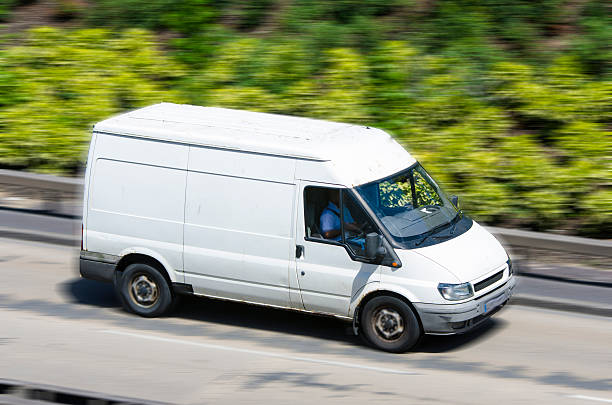 istock white moving van with blurred motion on the road 502789263
