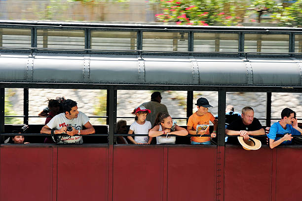 Anduze, France - July 14, 2014: The steam locomotive tourist train from Anduze has started and has its installed in the car to go to Saint-Jean-du-Gard travelers.