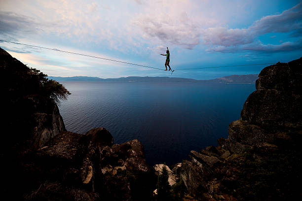 above all Slacklining in a dramatic setting  tightrope stock pictures, royalty-free photos & images