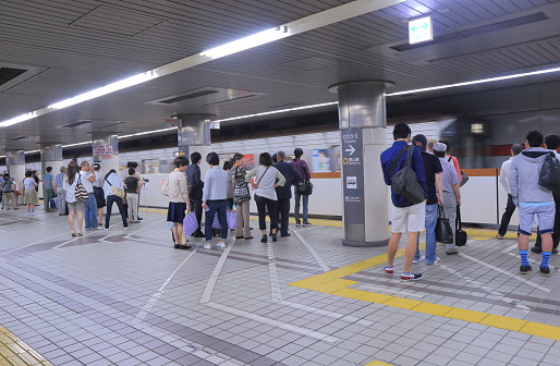 Nagoya Japan - 31 May, 2014: Commuters wait for subway at Nagoya subway station in Nagoya Japan.