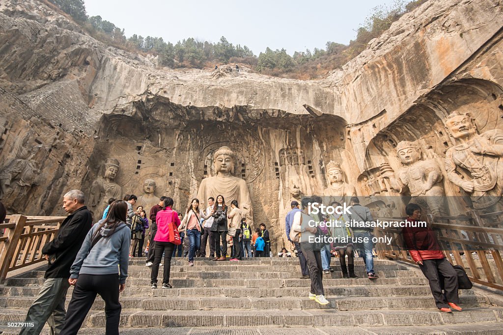 Longmen grottoes Luoyang,China - October 22,2013: Visitors at Longmen grottoes.It is one of the four notable grottoes in Luoyang,Henan,China . A UNESCO World Heritage Site. Ancient Stock Photo