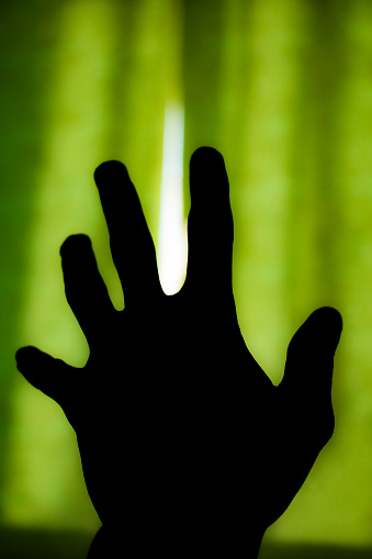 Human hand asks for help, and the light is visible in the distance.