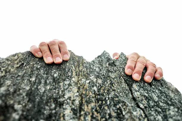 Photo of Hands Gripping the Rock Summit