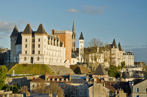 Pau, France, January 11, 2015 Historical center of Pau, capital of Bearn,  Royal city of Rey of France Henri IV pastimes with medieval Towers of Gaston Febus, followed by the Parlament of Navarra along Pyrenees Boulevard and the tower of the church Saint-Martin in the middle. Old city buildings are at foreground