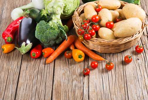 Assorted of useful vegetables on a wooden background