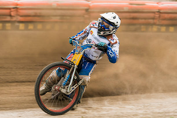 Unknown rider overcomes the track  Rivne, Ukraine - 11 October 2015: Unknown rider overcomes the track at the Open Cup Speedway to the day of the city Rivne bmx racing stock pictures, royalty-free photos & images