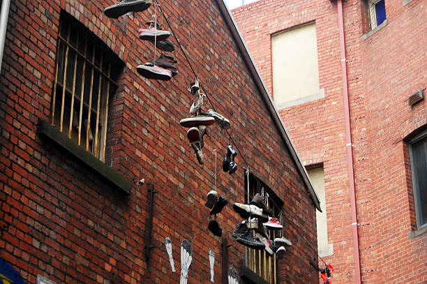 On a cloudy afternoon, the sight of sport shoes hanging overhead adds an intriguing touch to the landscape