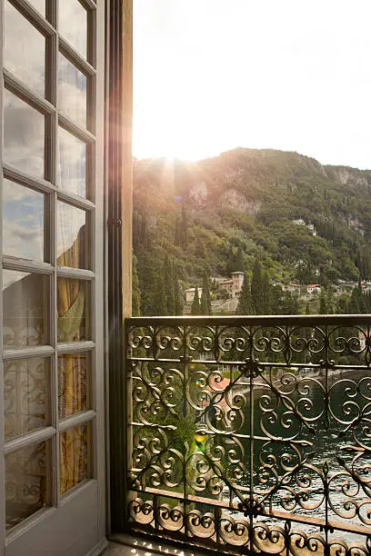 Window view to the landscape scenery of Lake Como at sunrise in the Varenna, Italy. 