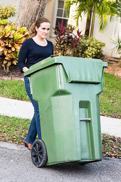 istock Hispanic Housewife pushing the trash can 502814502