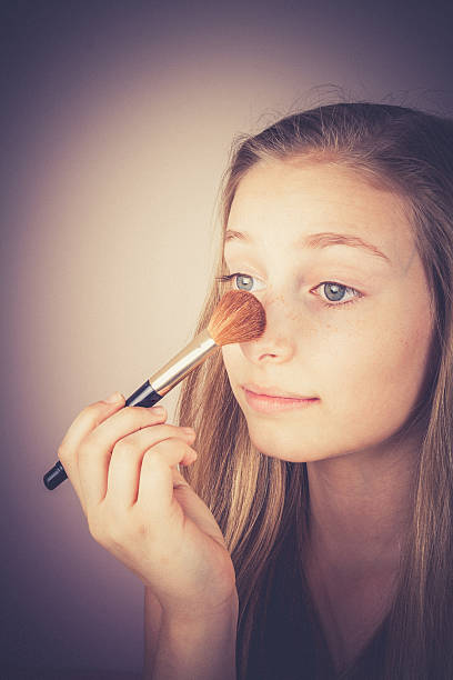 istock Blond girl, makeup brush trying, grain effect 502814948