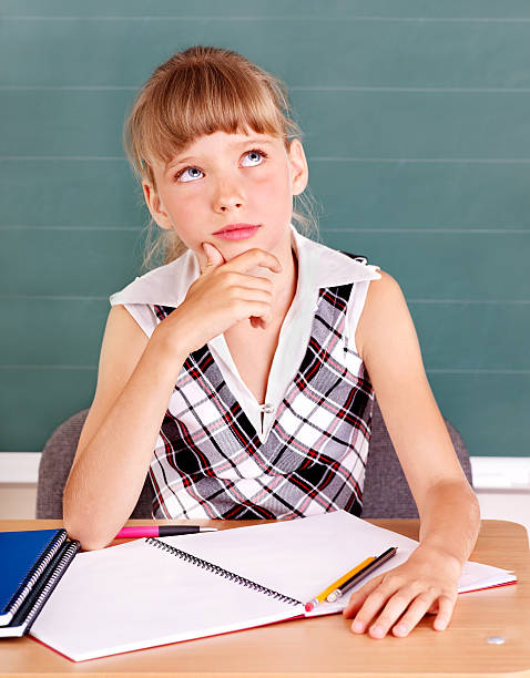 istock Schoolchild in classroom near blackboard. 502814989