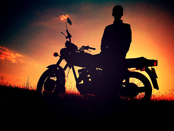 \nMan silhouette on a motorcycle