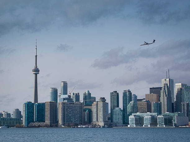 istock Toronto's CN Tower with airplane landing 502816684