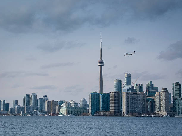 istock Toronto's CN Tower with airplane landing 502816854