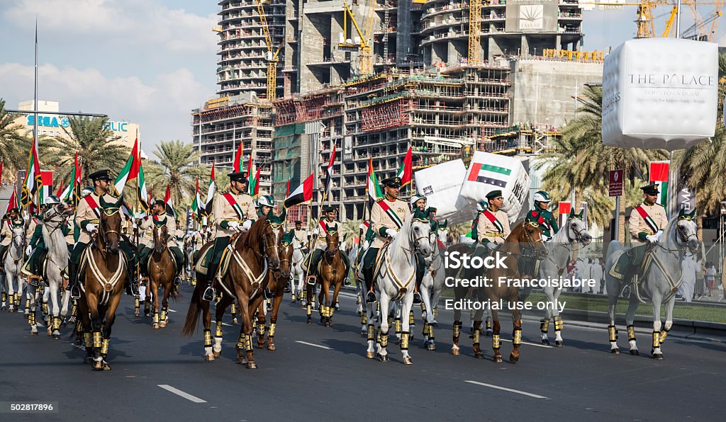 UAE National Day Dubai, United Arab Emirates, November 28, 2015: Mounted soldiers ride horses during celebrations for United Arab Emirates National Day in Dubai, United Arab Emirates 2015 Stock Photo