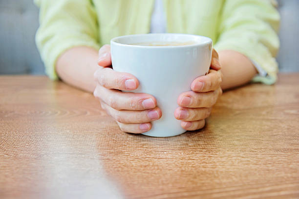 istock holding a cup of coffee 502818148