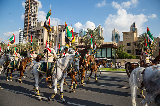 UAE National Day Dubai, United Arab Emirates, November 28, 2015: Mounted soldiers ride horses during celebrations for United Arab Emirates National Day in Dubai, United Arab Emirates arab man riding horse stock pictures, royalty-free photos & images
