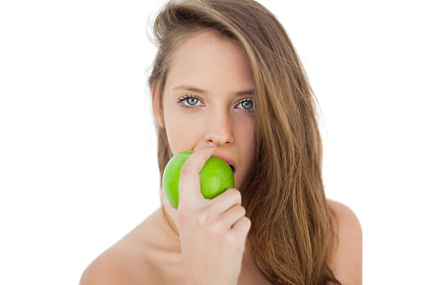 istock Wondering brunette model eating an apple 502818877