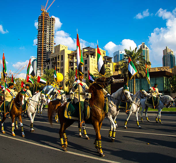 UAE National Day Dubai, United Arab Emirates, November 28, 2015: Mounted soldiers ride horses during celebrations for United Arab Emirates National Day in Dubai, United Arab Emirates arab man riding horse stock pictures, royalty-free photos & images