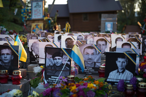 Kiev, Ukraine - September 14, 2015: A memorial with flowers, Ukrainian flags, and photos of those killed during the 2014 Euromaidan protest is located near Maidan Nezalezhnosti, the central square in Kiev, Ukraine.