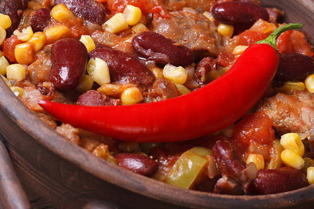 Mexican hot chili con carne soup in a bowl macro.
