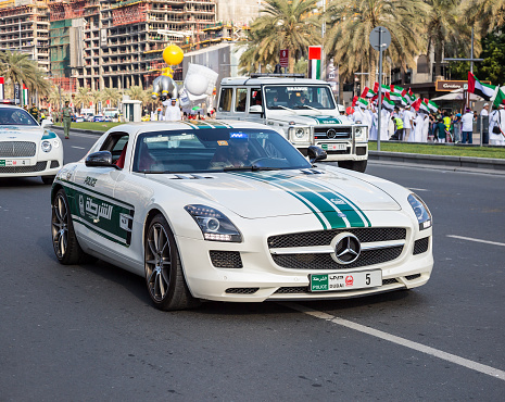 Dubai, United Arab Emirates, November 28, 2015: Dubai police cars Mercedes and Bentley taking part in the parade celebrations of the United Arab Emirates 44th National Day in Dubai, United Arab Emirates.