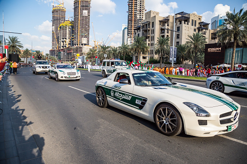 Dubai, United Arab Emirates, November 28, 2015: Dubai police cars Mercedes, Nissan and Bentley taking part in the parade celebrations of the United Arab Emirates 44th National Day in Dubai, United Arab Emirates.