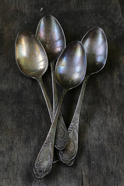 istock vintage silver spoons on a wooden background 502836360