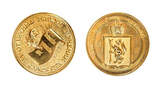 Gold school medal of Russia. The medal inscription \