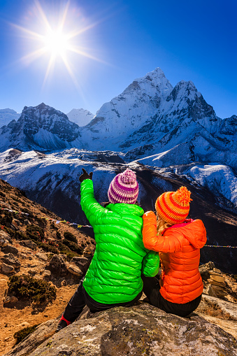 Young women admiring sunrise in Himalayas, Mount Ama Dablam on background. One woman is wearing green jacket, second woman wearing orange jacket. Mount Everest National Park. This is the highest national park in the world, with the entire park located above 3,000 m ( 9,700 ft). This park includes three peaks higher than 8,000 m, including Mt Everest. Therefore, most of the park area is very rugged and steep, with its terrain cut by deep rivers and glaciers. Unlike other parks in the plain areas, this park can be divided into four climate zones because of the rising altitude. 