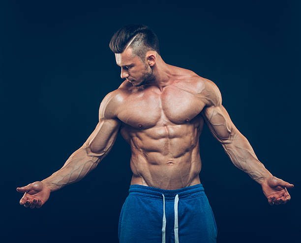 istock strong athletic man on black background 502839696