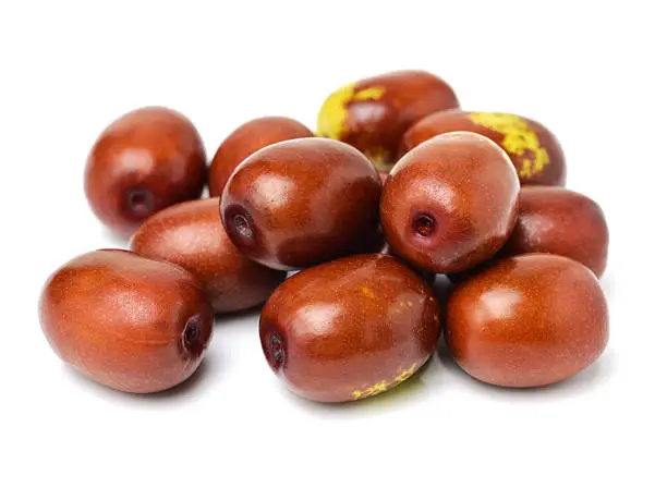 Fresh, yellow-red jujubes isolated on white.